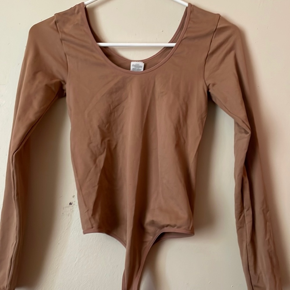 This is a pinkish/tan thong bodysuit extra small with a scoop neck